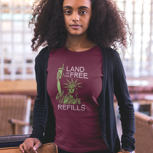 Woman wearing a maroon t-shirt with a design that says Land of the Free Refills.